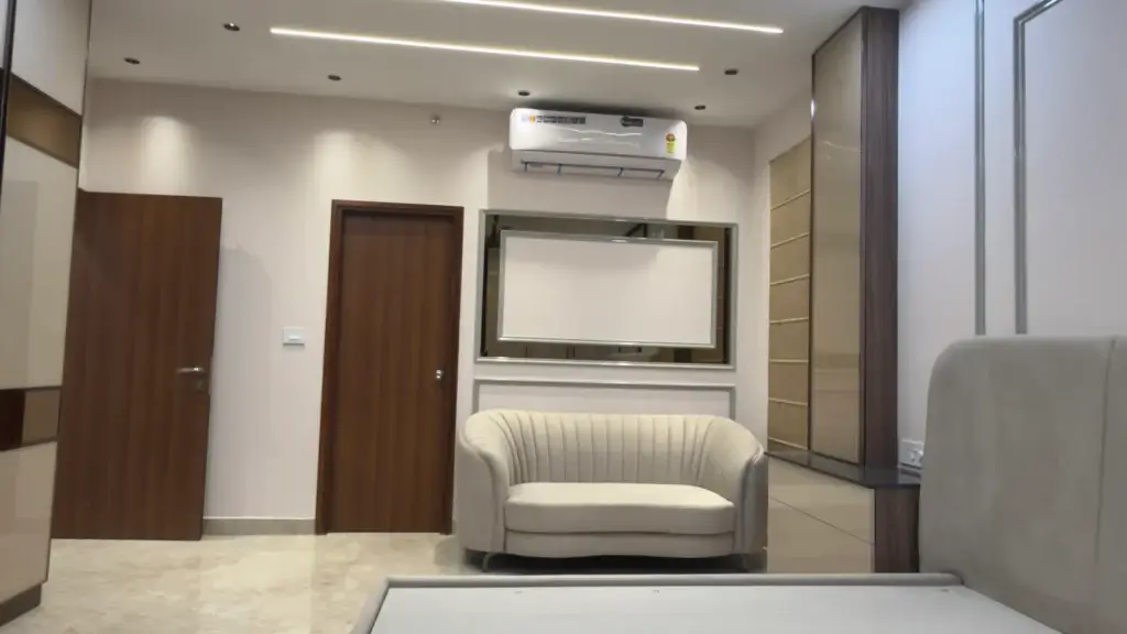 Modern bedroom interior with upholstered bed, built-in wardrobe, accent chair, and minimalist design