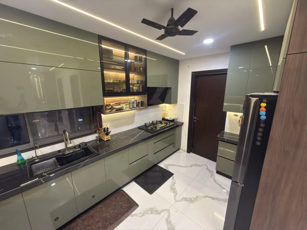 Modern kitchen with built-in storage unit, cabinets, and contemporary interior design.