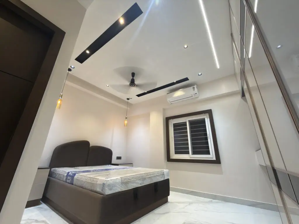 Modern bedroom with windows, ceiling fan, comfortable bed, and contemporary interior design.