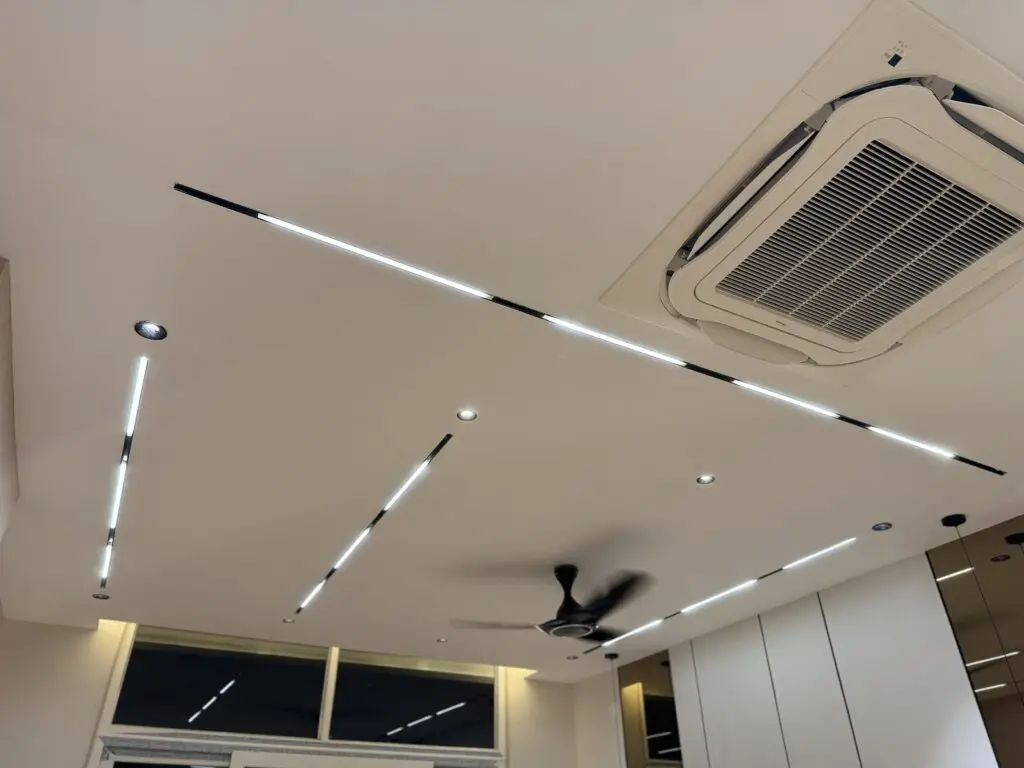 modern false celing design with LED strip lights and ceiling cassette air consitioner.