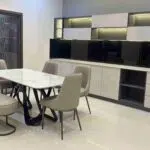 modern dining room featuring a stylish dining table, built-in storage cabinets, and functional contemporary déco